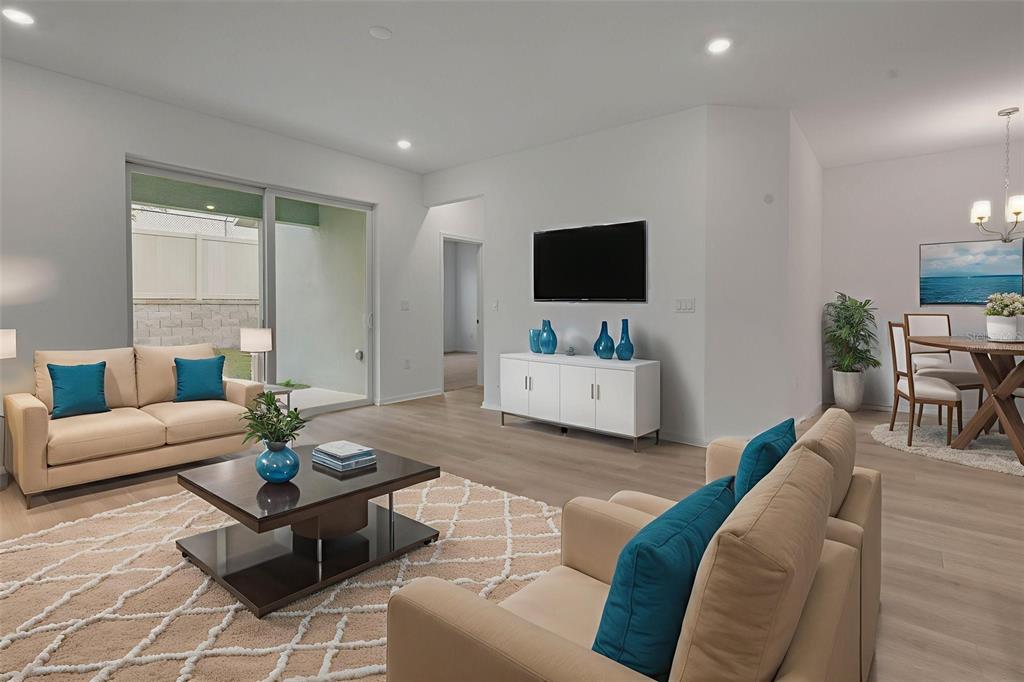 2878 Supermarine Road Tavares, FL 32778 - Photo 22 of 23 a living room with furniture and a flat screen tv