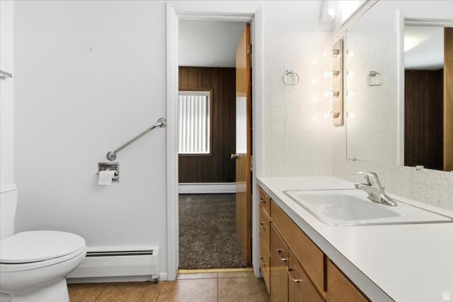 217 East 400 South Spring City, UT 84662 - Photo 21 of 71 Bathroom with vanity, a baseboard heating unit, light tile patterned flooring, and light carpet