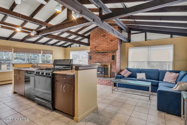 a kitchen with stainless steel appliances granite countertop a stove and a microwave