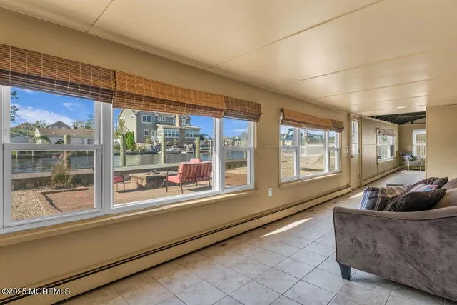 a living room with furniture and large windows
