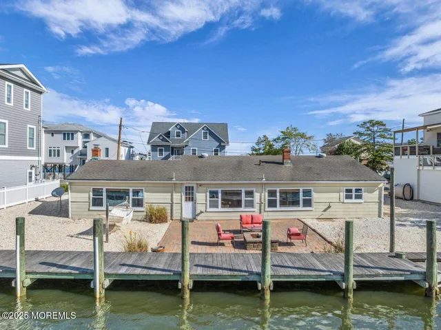 a view of house with swimming pool and seating