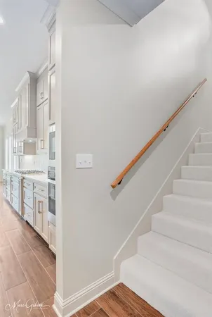 a kitchen with white cabinets and sink