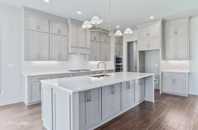 a kitchen with kitchen island a sink stainless steel appliances and cabinets
