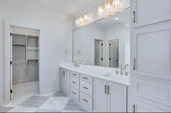 a spacious bathroom with a double vanity sink mirror and double