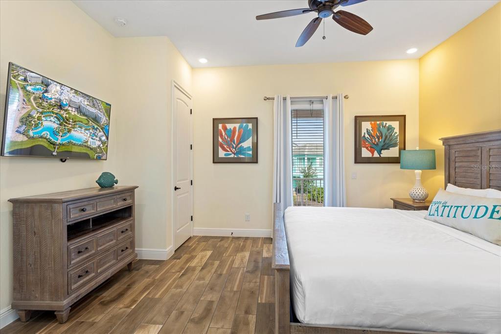 8063 Knee Deep Road Kissimmee, FL 34747 - Photo 13 of 24 a bedroom with a bed and a flat screen tv