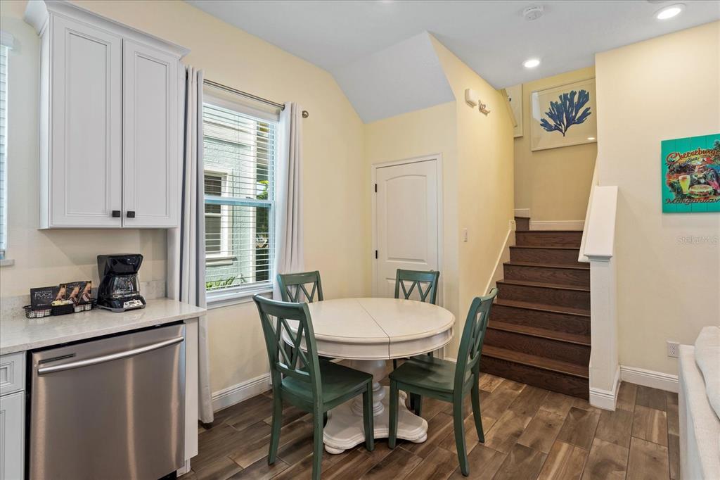 8063 Knee Deep Road Kissimmee, FL 34747 - Photo 14 of 24 a kitchen with a table chairs and a refrigerator