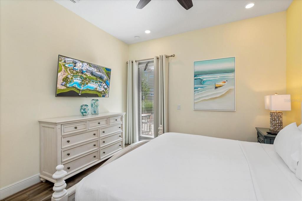 8063 Knee Deep Road Kissimmee, FL 34747 - Photo 17 of 24 a bedroom with a bed and a flat screen tv