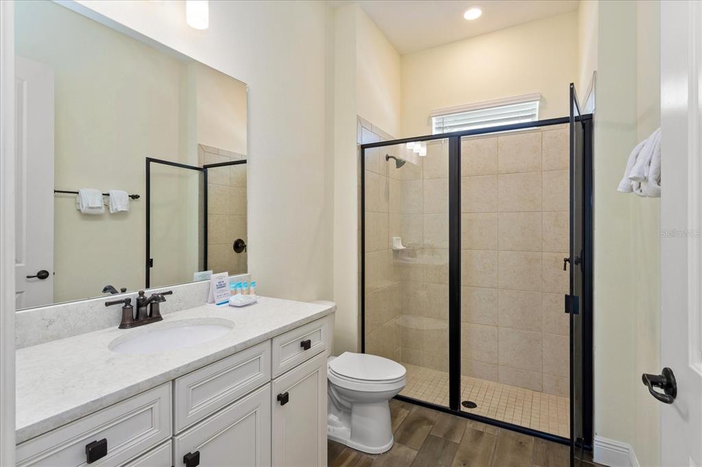 8063 Knee Deep Road Kissimmee, FL 34747 - Photo 19 of 24 a bathroom with a sink toilet and shower