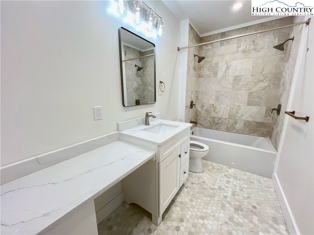 505 Camp Rock Road Boone, NC 28607 - Photo 15 of 31 a bathroom with a sink a toilet a mirror and shower