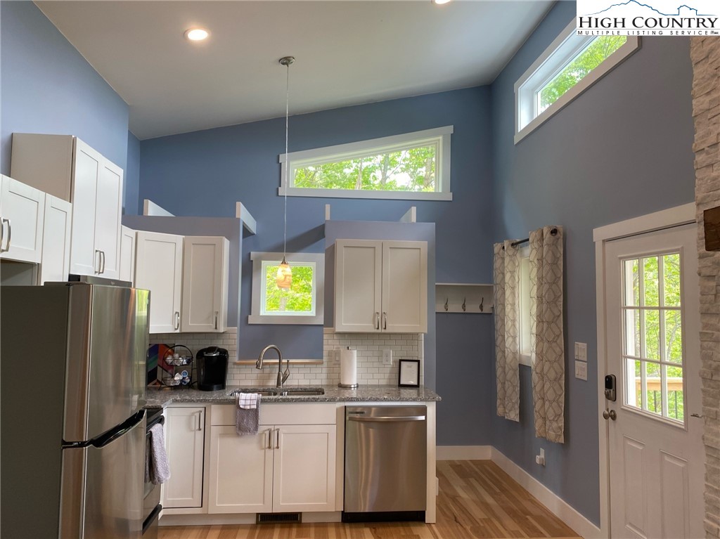 505 Camp Rock Road Boone, NC 28607 - Photo 5 of 31 a kitchen with stainless steel appliances granite countertop a refrigerator a stove a sink and a window