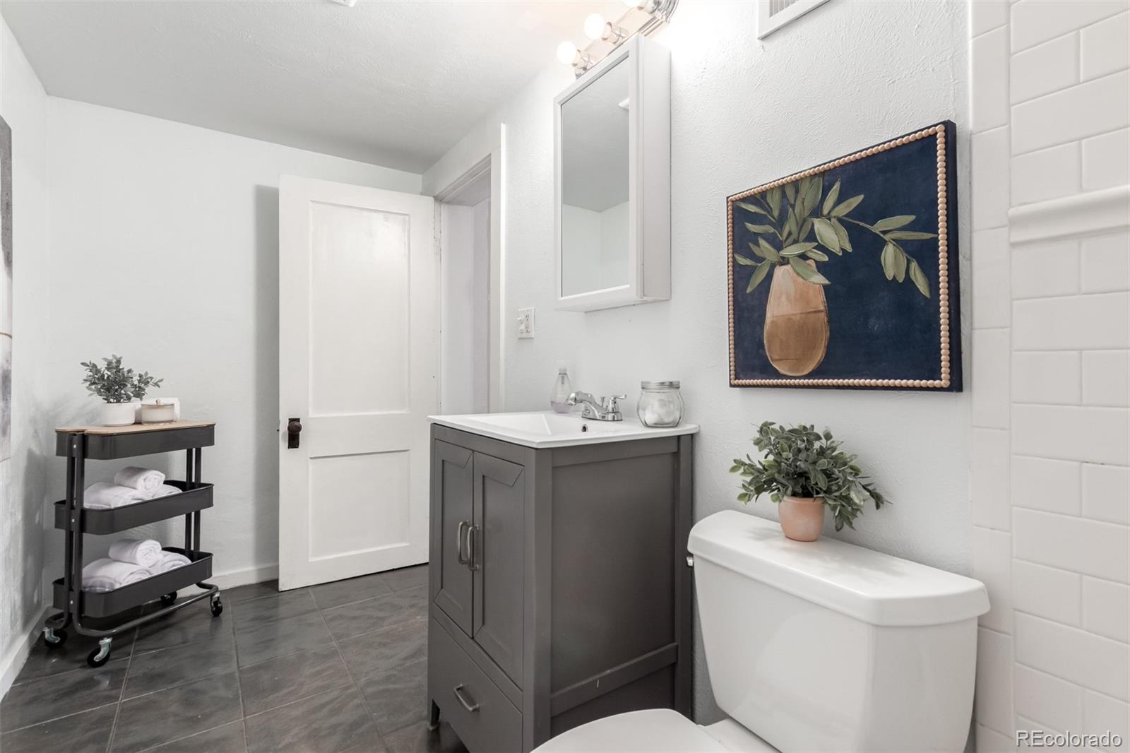 1284 Columbine Street, Unit 2 Denver, CO 80206 - Photo 8 of 34 a bathroom with a toilet sink and a mirror