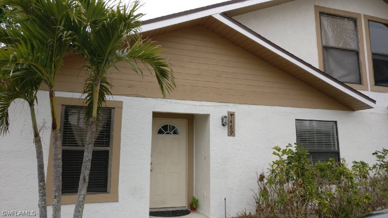 7489 Pebble Beach Road Fort Myers, FL 33967 - Photo 1 of 7 a view of a house with a tree