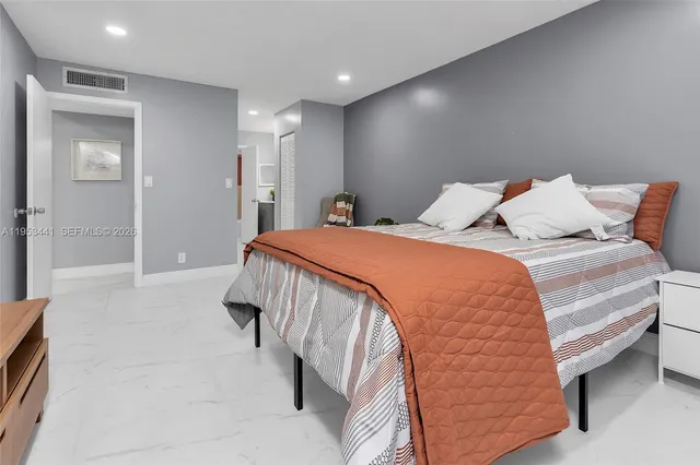 a bedroom with a bed and a television