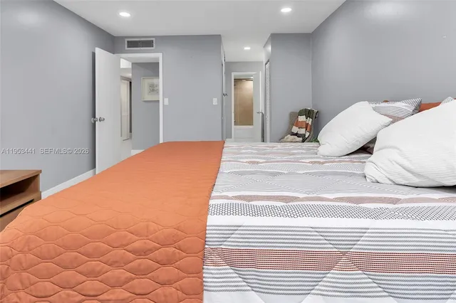 a bedroom with furniture and a flat screen tv