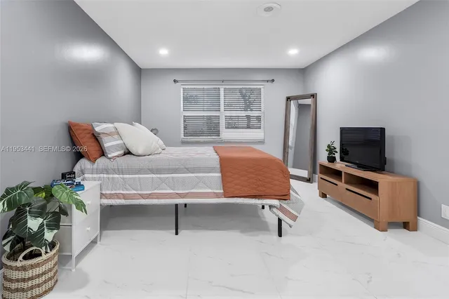 a white toilet sitting next to a bath tub