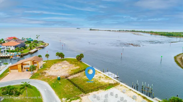 a view of a lake with chairs