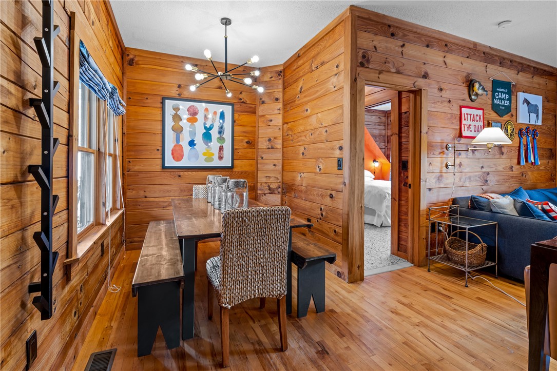 203 Little Lane Seneca, SC 29672 - Photo 12 of 48 Warm wood paneling defines this inviting dining space, ideal for gatherings.