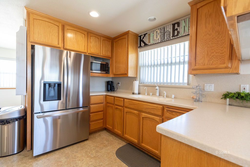 6542 Ridgecrest Boulevard Inyokern, CA 93527 - Photo 16 of 50 a kitchen with stainless steel appliances granite countertop a refrigerator a sink a stove and a refrigerator
