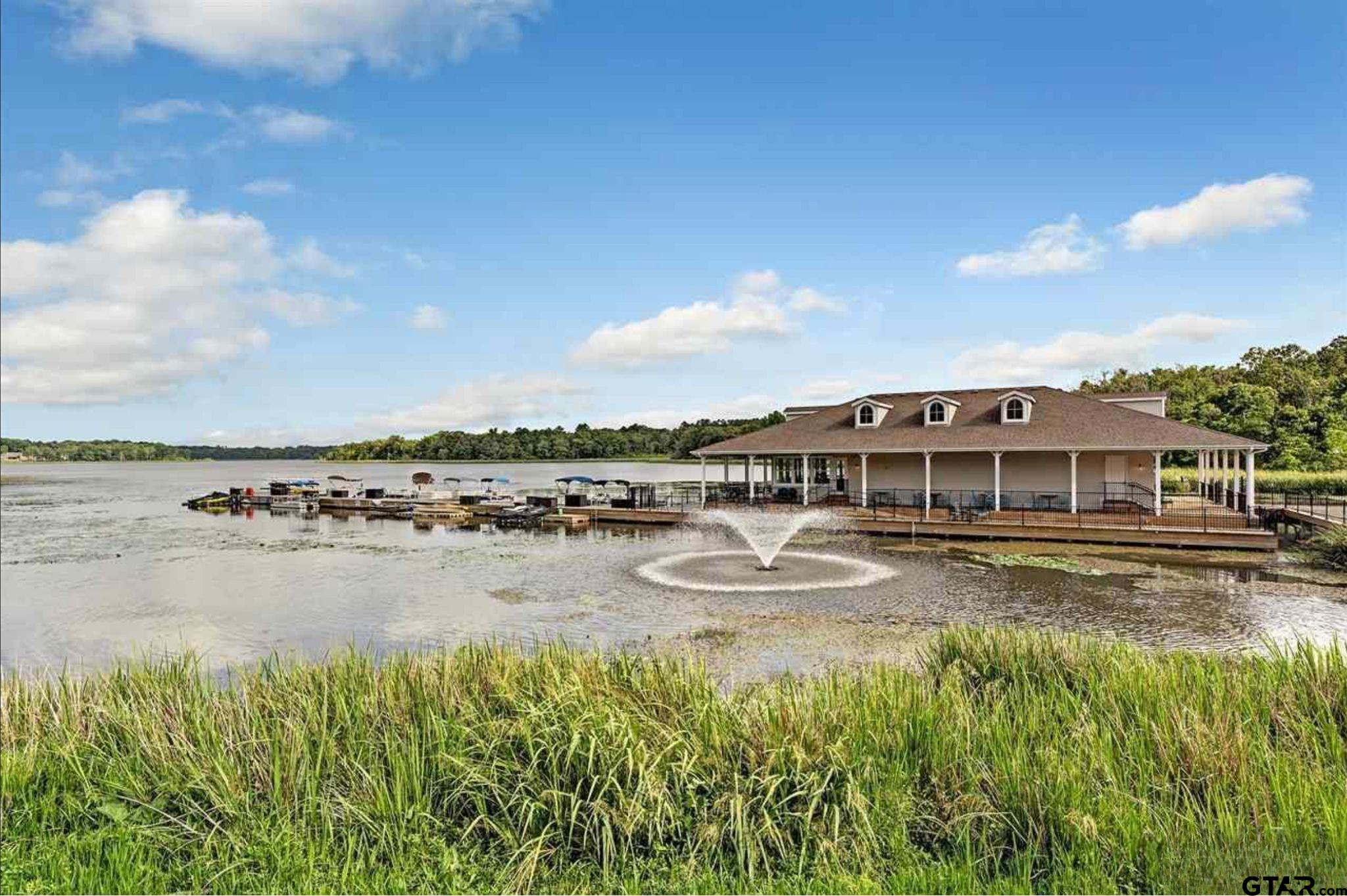 4856 Nicklaus Court Tyler, TX 75709 - Photo 24 of 32 a view of a lake with building in front of it