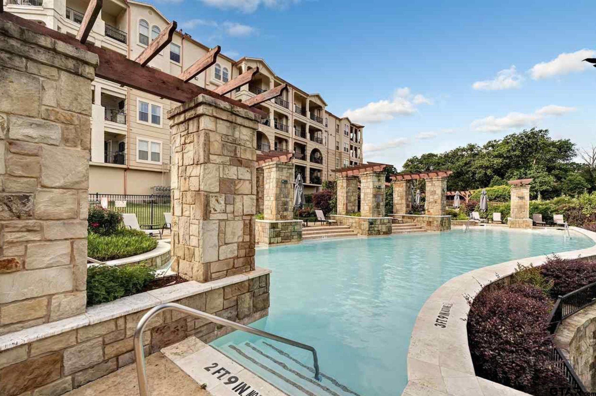 4856 Nicklaus Court Tyler, TX 75709 - Photo 25 of 32 a view of swimming pool with outdoor seating and plants