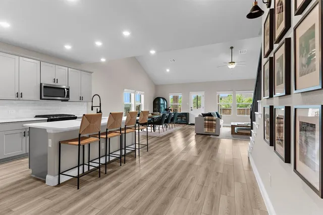 a kitchen with sink cabinets and wooden floor