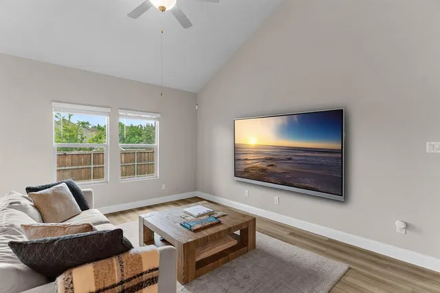 a living room with furniture and a flat screen tv