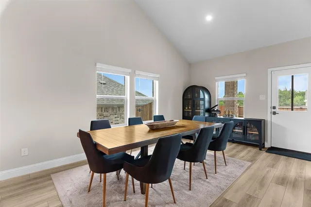 a view of a dining room with a table and chairs