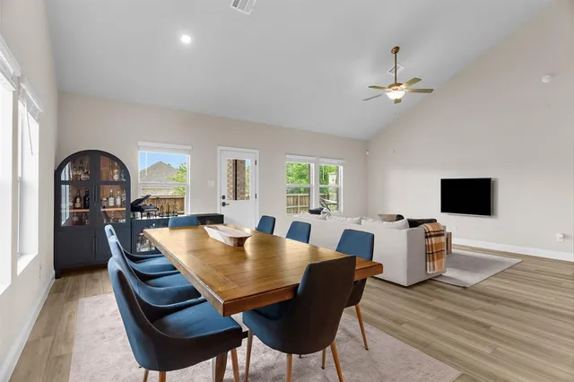 a view of a dining room with furniture and a window