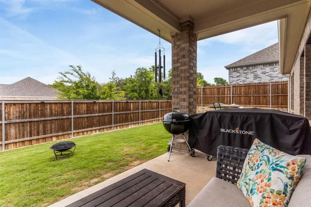 a view of a chair and table on the deck