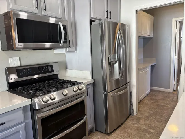 a kitchen with cabinets and stainless steel appliances