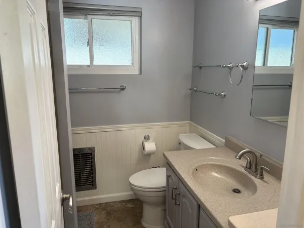 a bathroom with a sink toilet and mirror