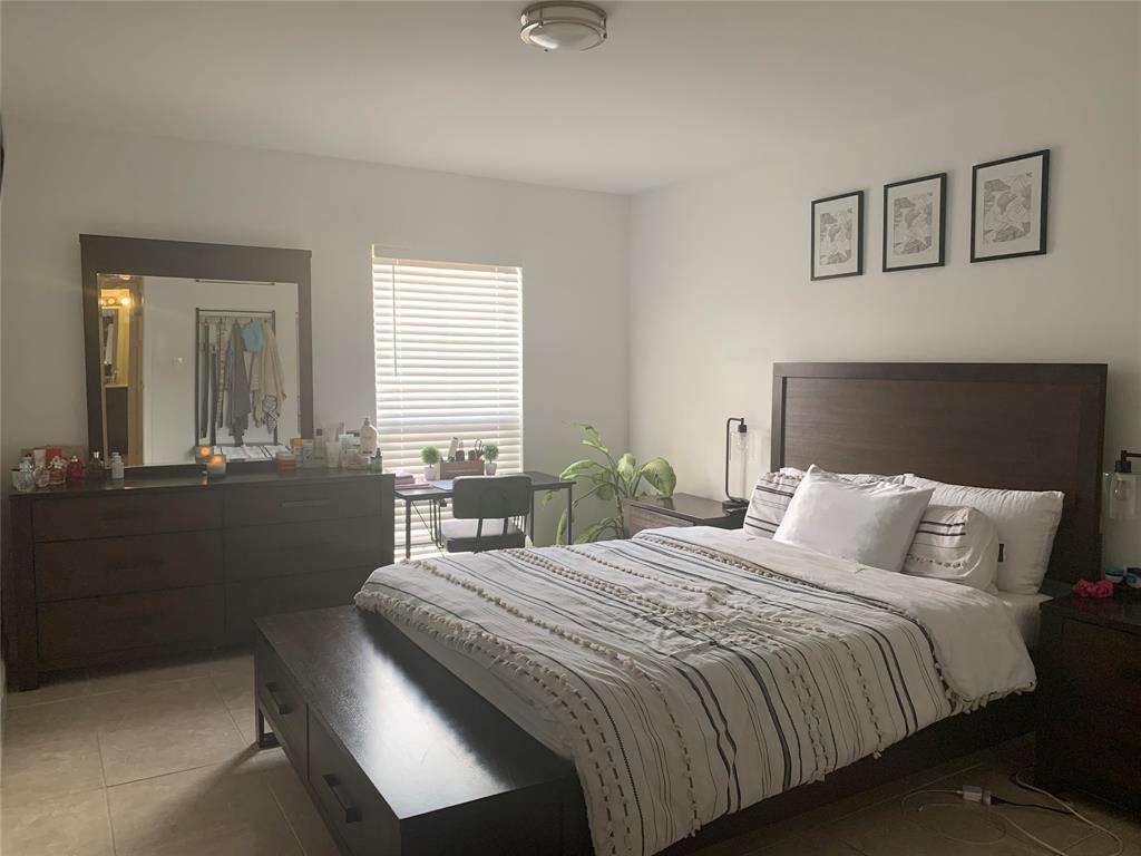 927 Riverside Drive, Unit 335 Coral Springs, FL 33071 - Photo 18 of 23 a bedroom with a bed and a chandelier