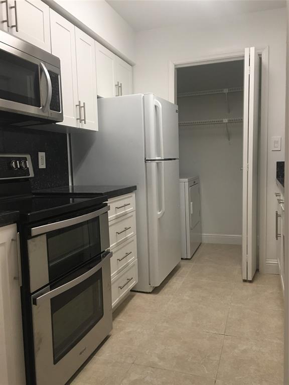 927 Riverside Drive, Unit 335 Coral Springs, FL 33071 - Photo 2 of 23 a kitchen with a refrigerator stove and microwave