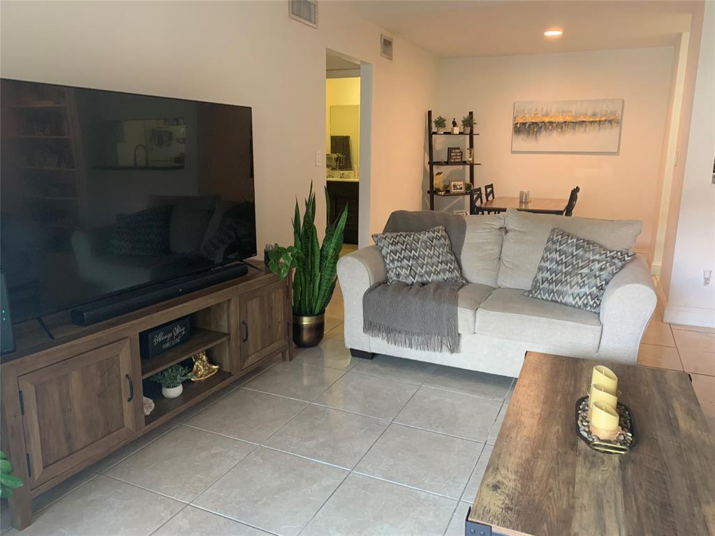 927 Riverside Drive, Unit 335 Coral Springs, FL 33071 - Photo 21 of 23 a living room with furniture and a flat screen tv