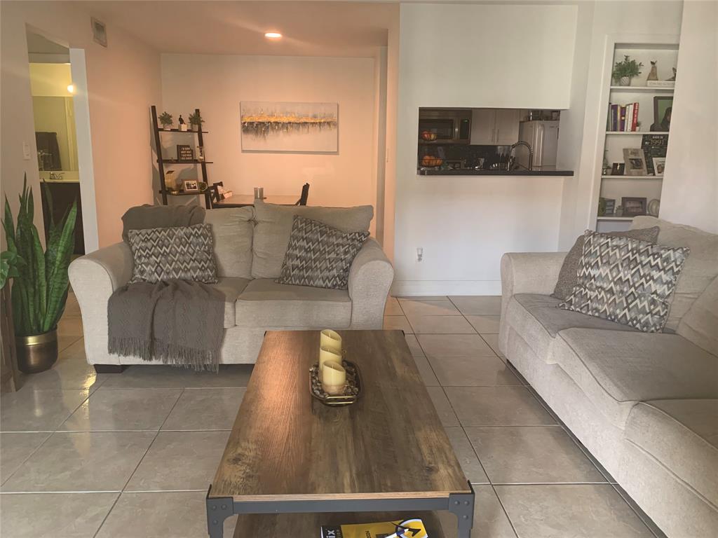 927 Riverside Drive, Unit 335 Coral Springs, FL 33071 - Photo 23 of 23 a living room with furniture and a flat screen tv