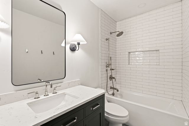 870 North Ada Loop Lehi, UT 84048 - Photo 41 of 51 Bathroom featuring a white subway tile shower surround with a recessed niche, a built-in tub, and a rain showerhead