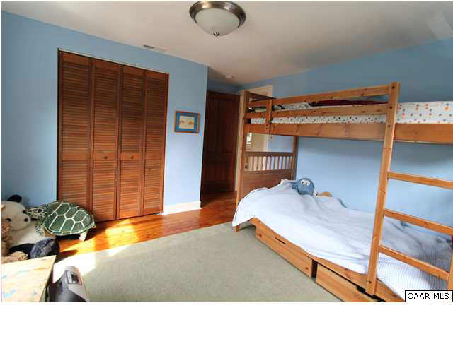 129 Goodman Street Charlottesville, VA 22902 - Photo 14 of 25 a bedroom with a bed and a window