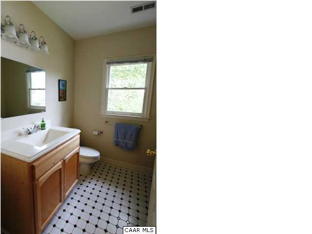129 Goodman Street Charlottesville, VA 22902 - Photo 19 of 25 a bathroom with a sink a toilet and a mirror