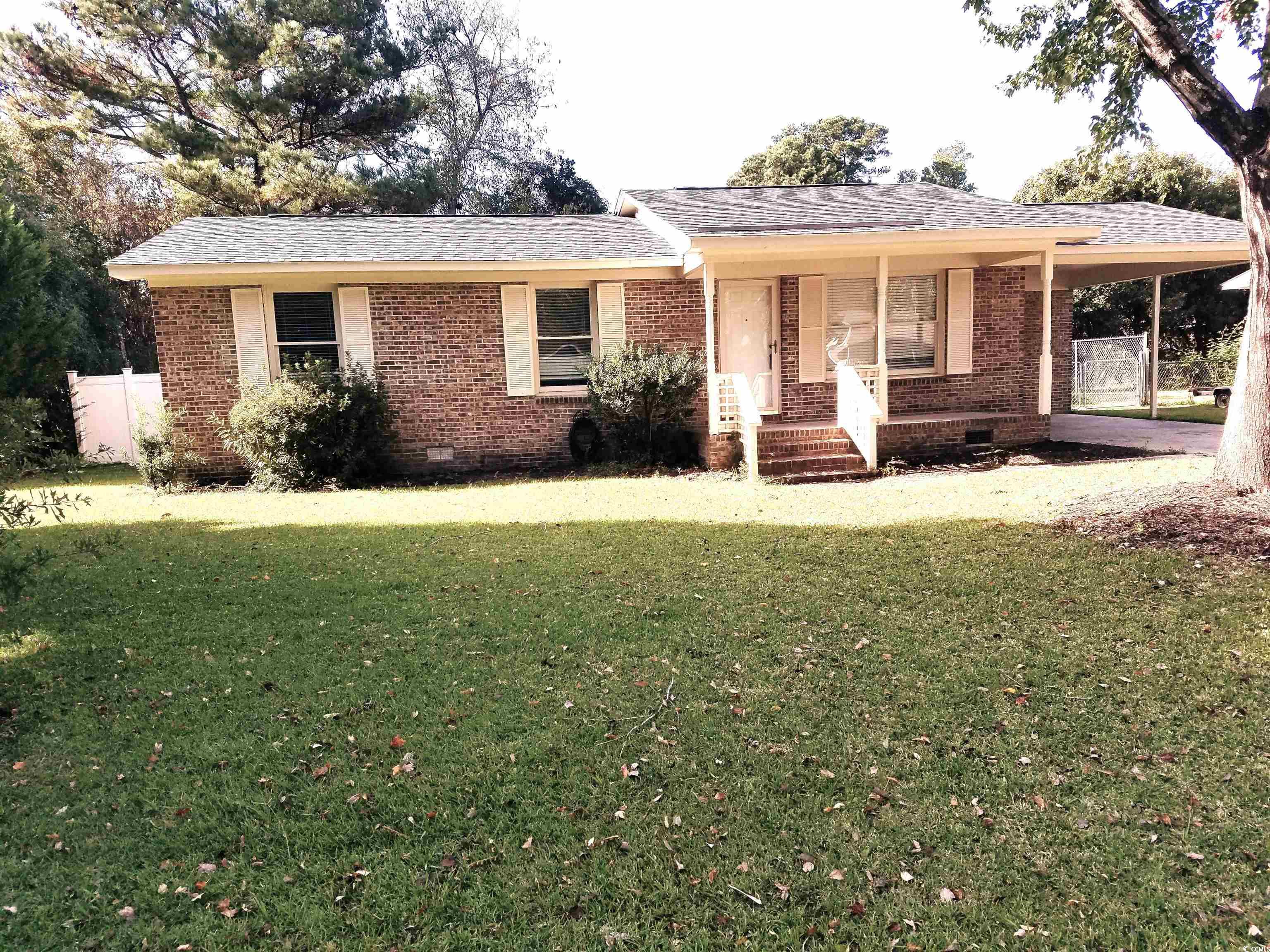615 Burcale Rd Circle Myrtle Beach, SC 29579 - Photo 1 of 17 Ranch-style home with a porch, brick siding, an attached carport, and driveway