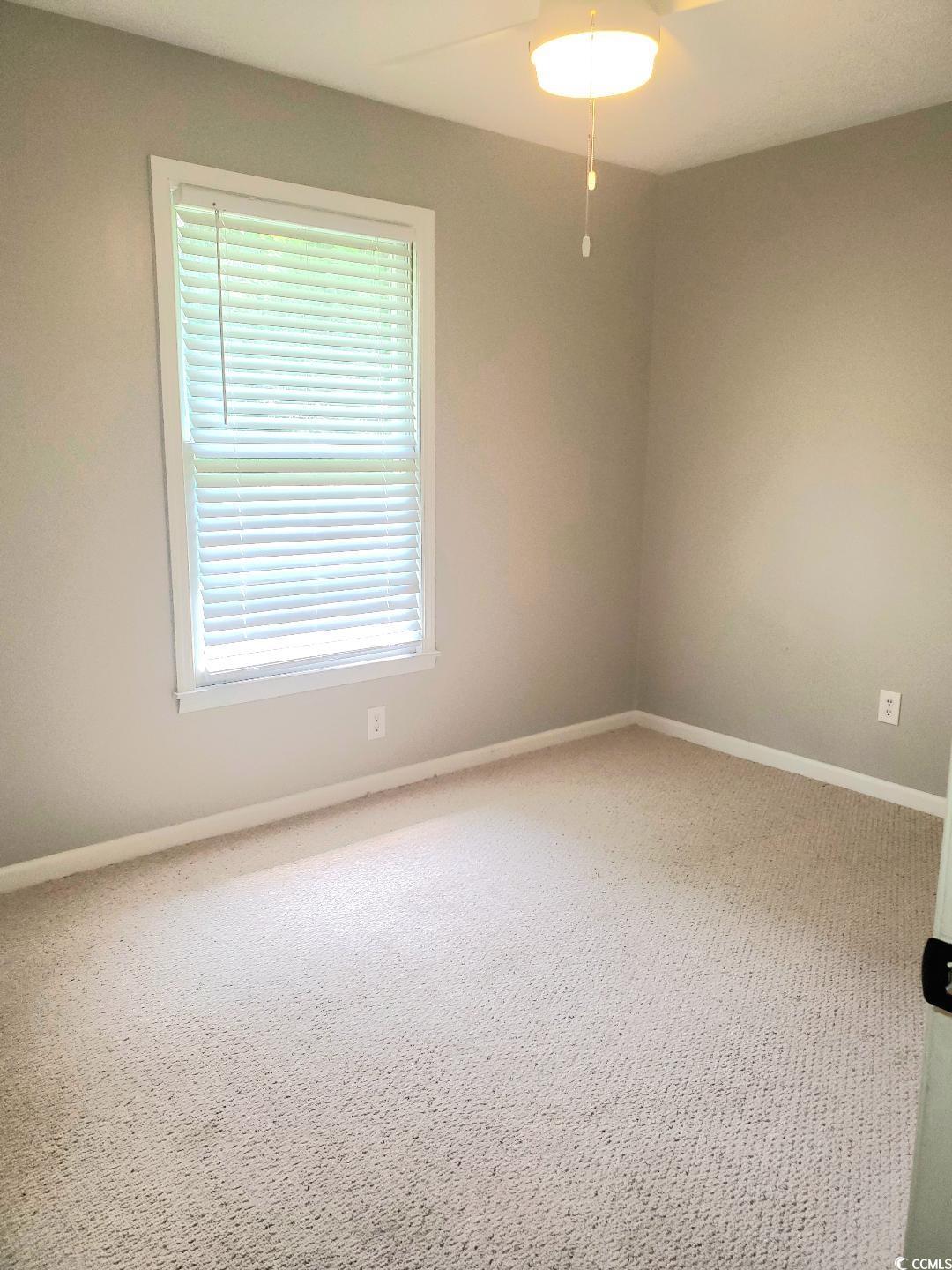 615 Burcale Rd Circle Myrtle Beach, SC 29579 - Photo 13 of 17 Unfurnished room with baseboards, a ceiling fan, and carpet flooring