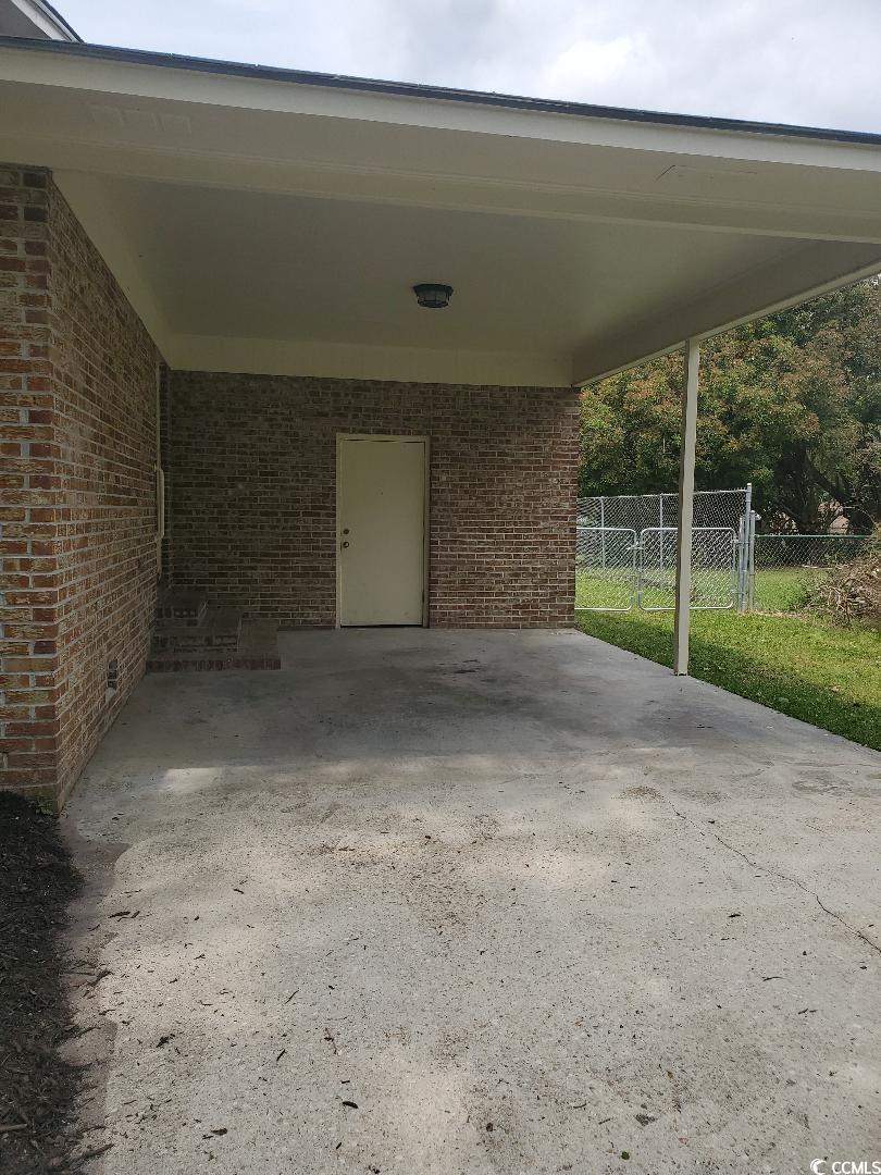615 Burcale Rd Circle Myrtle Beach, SC 29579 - Photo 14 of 17 View of patio with fence and a carport