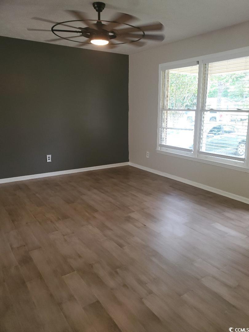 615 Burcale Rd Circle Myrtle Beach, SC 29579 - Photo 4 of 17 Unfurnished room featuring ceiling fan, baseboards, and wood finished floors