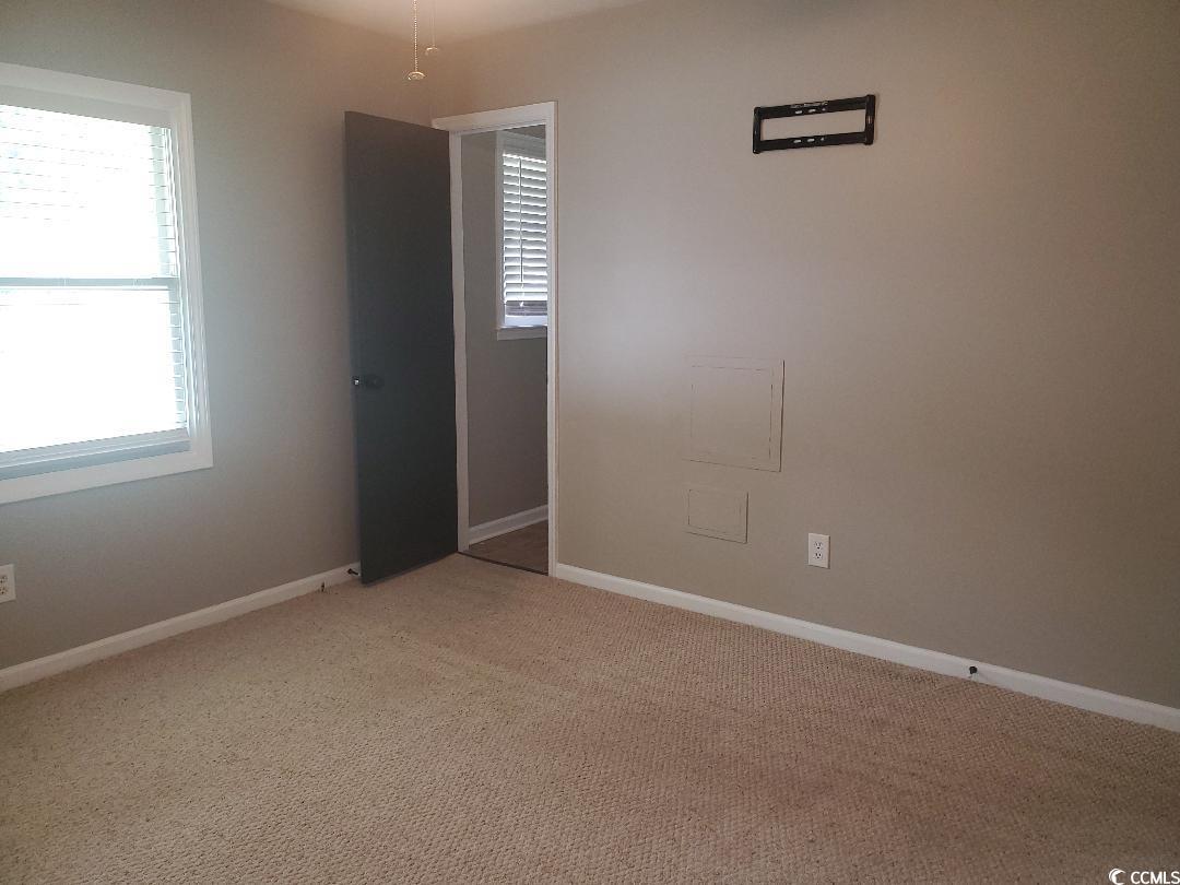 615 Burcale Rd Circle Myrtle Beach, SC 29579 - Photo 7 of 17 Unfurnished room featuring baseboards and light carpet