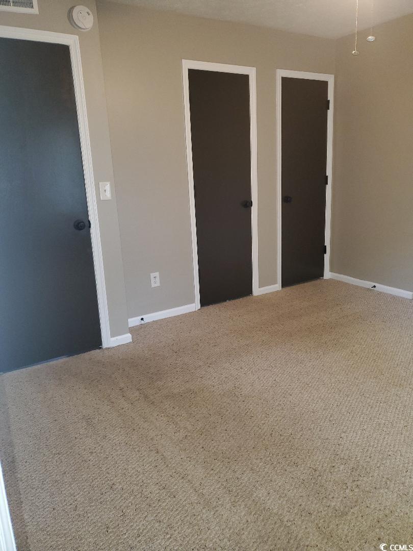 615 Burcale Rd Circle Myrtle Beach, SC 29579 - Photo 8 of 17 Carpeted empty room featuring visible vents and baseboards