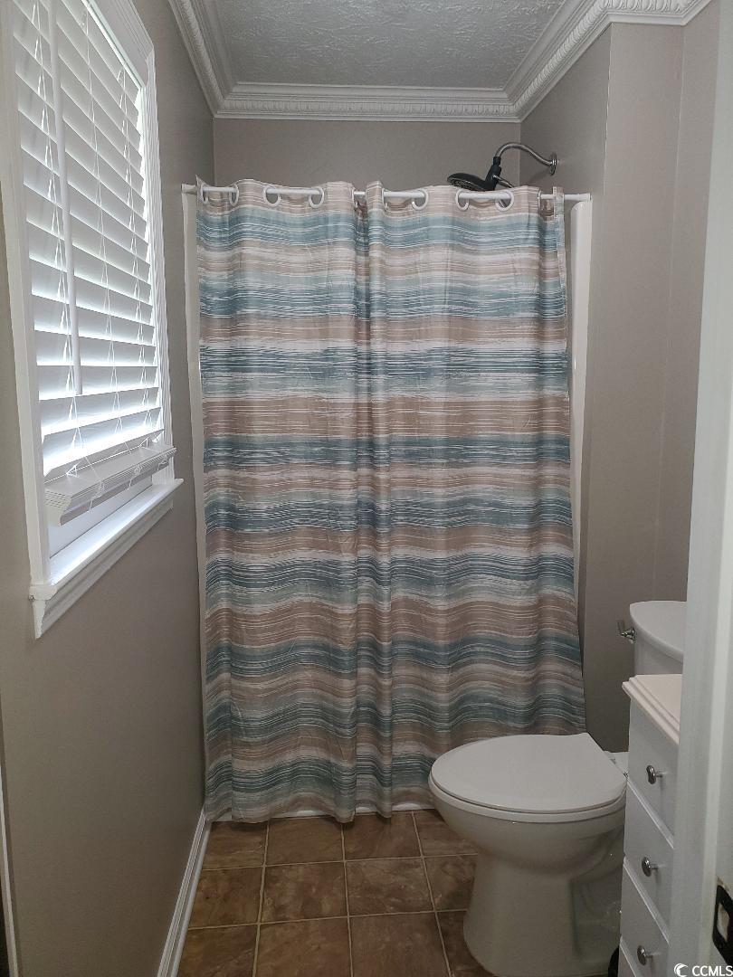 615 Burcale Rd Circle Myrtle Beach, SC 29579 - Photo 9 of 17 Bathroom featuring curtained shower, tile patterned floors, toilet, vanity, and crown molding