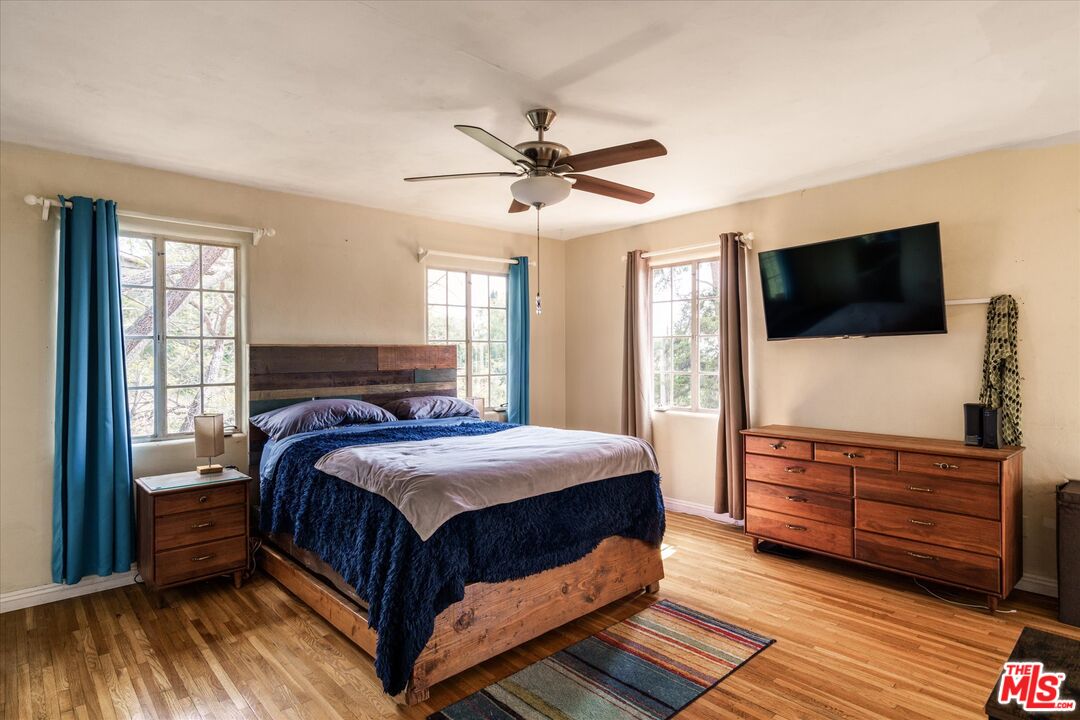 11111 Tujunga Canyon Boulevard Tujunga, CA 91042 - Photo 20 of 38 a bedroom with a bed and a flat screen tv