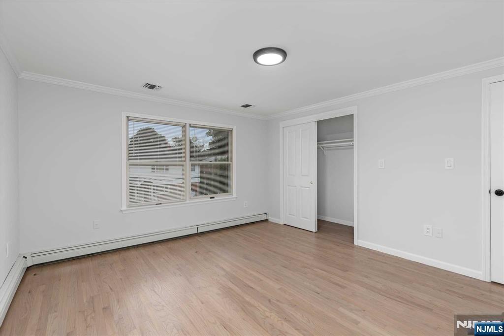 4 Coppola Street, Unit 2 Nutley, NJ 07110 - Photo 11 of 14 an empty room with wooden floor and windows