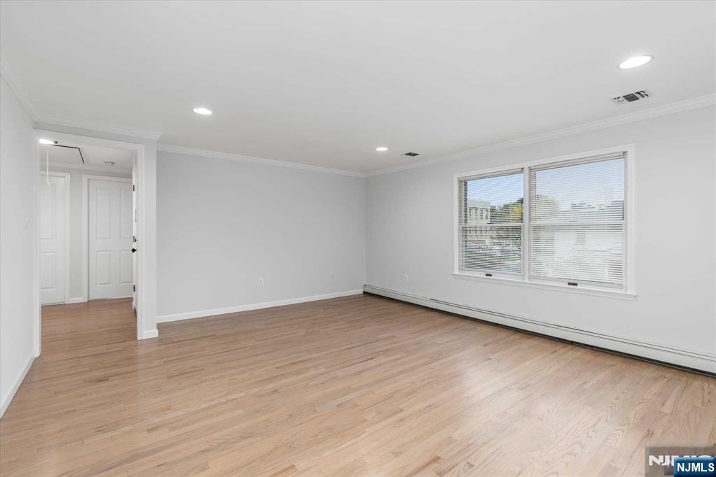 4 Coppola Street, Unit 2 Nutley, NJ 07110 - Photo 5 of 14 an empty room with wooden floor and windows