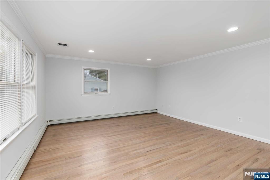 4 Coppola Street, Unit 2 Nutley, NJ 07110 - Photo 6 of 14 an empty room with wooden floor and windows