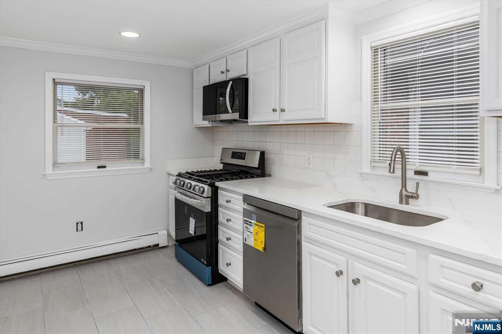 4 Coppola Street, Unit 2 Nutley, NJ 07110 - Photo 8 of 14 a kitchen with granite countertop white cabinets and stainless steel appliances